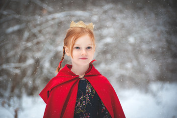 Girl in a red coat with a gold crown on her head