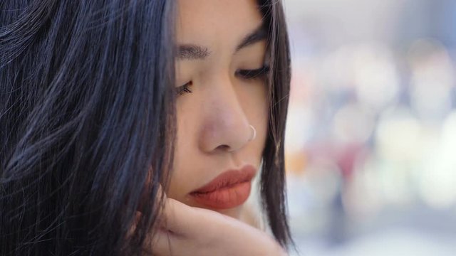 Thoughtful worried asian pretty woman's face-macro