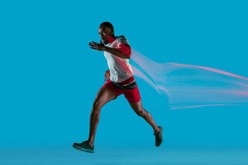 Fototapeta na wymiar Full length portrait of active young muscular running man,