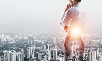 Concept of business success and control with confident boss against cityscape background