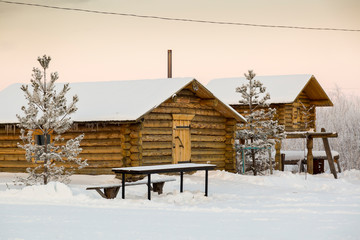 Two chopped wooden huts at the hunters' camp