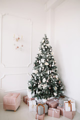 New Year festive interior. Holiday concept. Decorated Christmas tree with gifts. 