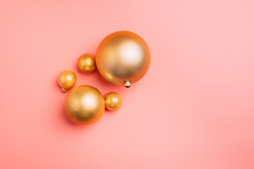 Gold and pink Christmas balls on wite background. Flat lay, top view copy space