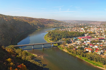Fototapeta premium Wide angle landscape view of Zalishchyky town and canyon with Dnister River. Autumn landscape. Ternopil region, Ukraine