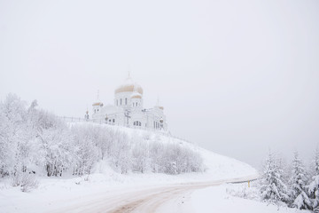 Orthodox church in winter, Russian Federation. Belogorsky Monastery. White background. 