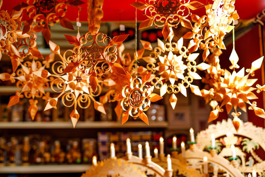 Colorful close up details of christmas fair market. Wooden selfmade stars decorations for sales. Xmas market in Germany with traditional decorative toys.