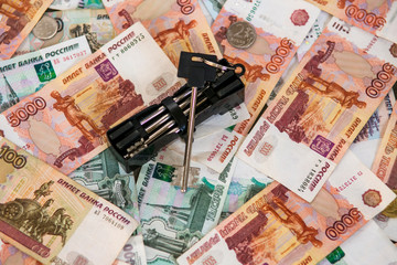 Mortgage loan concept. Keys of a new house or flat on a pile of Russian money (rubles).