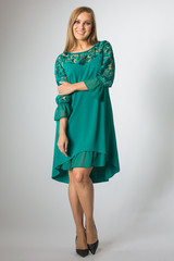 Fototapeta premium Beautiful caucasian girl posing in green dress