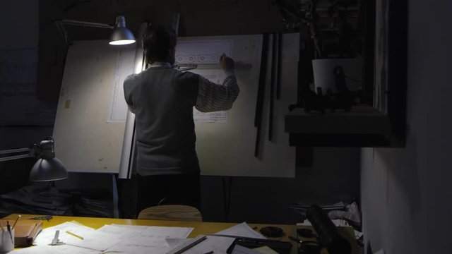 Engineer Draws a Technical Drawing on Drawing Board
