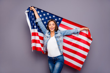 Cute sweet lovely excited smiling lady emigrant worker  holding USA american flag behind back,...