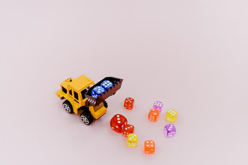 Obraz premium Colorful dices on light pink background, luck and gambling concept