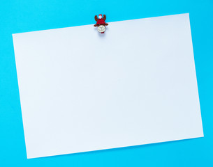 empty white square sheet of paper on a blue background