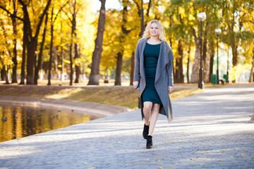 Portrait of a young beautiful woman in gray coat