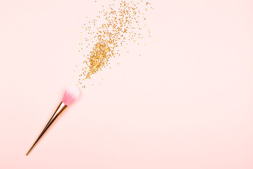 Pink makeup brush and confetti