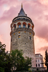 Fototapeta na wymiar Galata Tower at purple night. Historical building or structure in Istanbul, Turkey. Beautiful view of old Galata Tower in twilight. One of the most famous and top rated tourist attraction in Istanbul.
