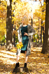 Fototapeta premium Portrait of a young beautiful woman in gray coat