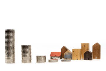 Wood house model and row of coin money on white background, isolate, Real Estate market, Trading Estate, Mortgage Concepts