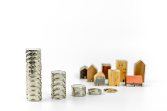 Wood house model and row of coin money on white background, isolate, Real Estate market, Trading Estate, Mortgage Concepts