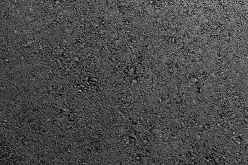 Texture of fresh hot asphalt. Black background resembling anthracite.