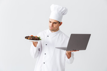 Serious chef cook wearing uniform standing