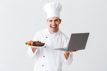 Excited chef cook wearing uniform standing