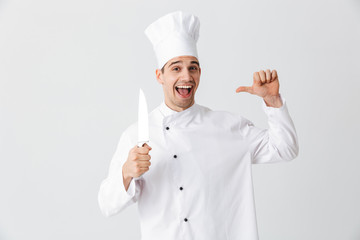 Happy chef cook wearing uniform holding a knife