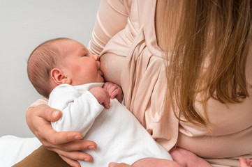 Mother is breastfeeding her newborn baby