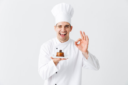 Cheerful man chef cook wearing uniform