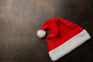 Red Santa Claus hat on a dark brown background. with space for text. Christmas. new Year.