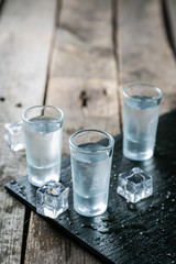 Traditional greek vodka - ouzo in shot glasses - obrazy, fototapety, plakaty