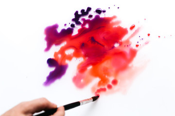 a spot of red paint on a white background.