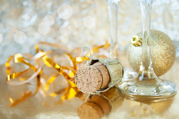 new year ball and christmas tree branch on brilliant glitter background, merry christmas and happy new year