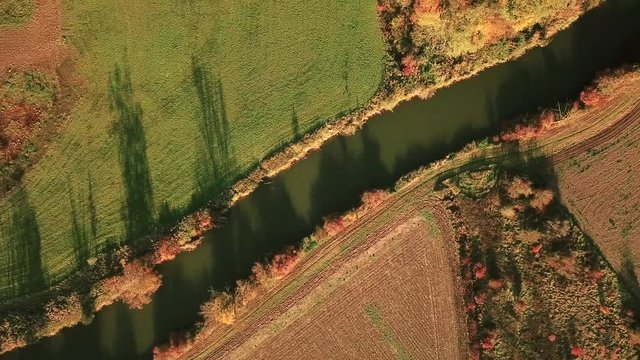 Tracking shot of river in German countryside in fall