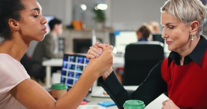 Company leader beating her employee at arm-wrestling