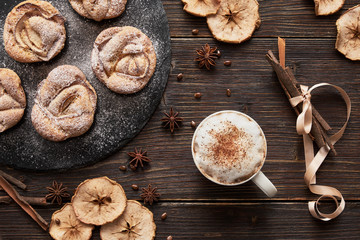 notebook, muffins on black plate, cappuccino cup