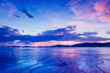 Sunset at the Sea with boat and cloudy sky