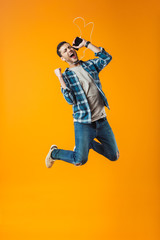 Excited young man wearing plaid shirt