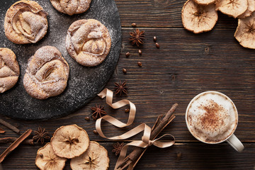 notebook, muffins on black plate, cappuccino cup