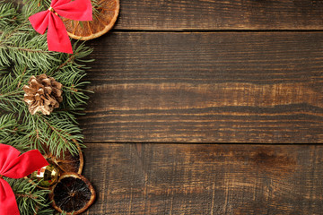 New Year and Christmas frame for text with a Christmas tree and colored Christmas decorations on a brown background. view from above.