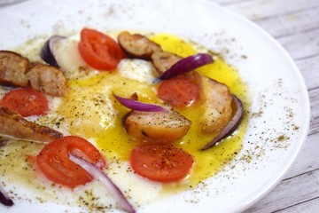 Delicious scrambled eggs with tomatoes and sausages for Breakfast.