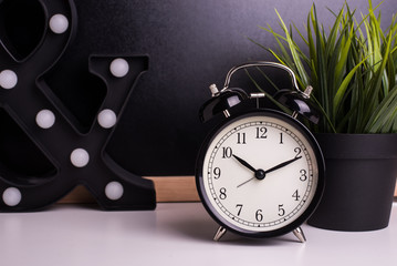 vintage alarm clock on the background of a blackboard