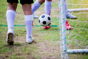 Fototapeta premium Boy soccer players trap and control the ball for shoot at front of goal.