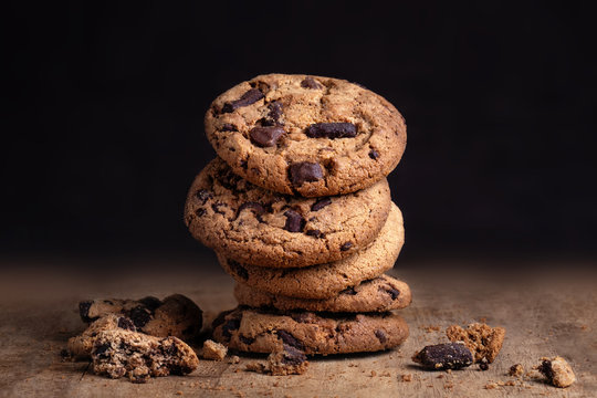 Chocolate cookies on old wood table. Chocolate chip cookies on dark   background. Copy space