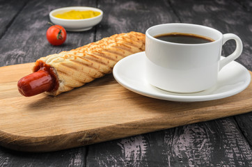 French Hot Dog and coffee on wooden table