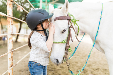 Affectionate Girl Kissing Horse