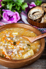 Pickle soup on old wooden table.