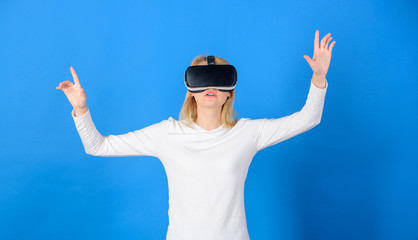 Pretty woman playing game in virtual reality glasses. Young woman using a virtual reality headset....