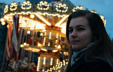 portrait of a girl in front of carousel