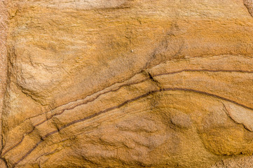 Sandsteinmauer, Sandstein mit künstlerischen Mustern Schraffuren Reliefartigen Formen auf der Oberfläche, Detailaufnahme