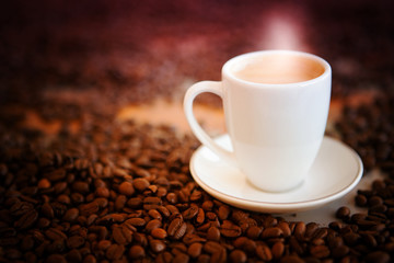 cup of fresh coffee on table with coffee beans